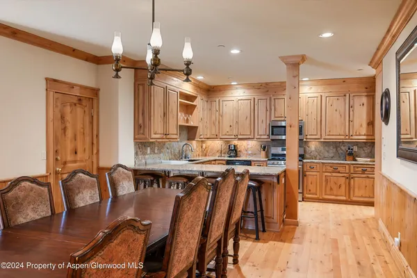 a large kitchen with lots of counter top space and stainless steel appliances