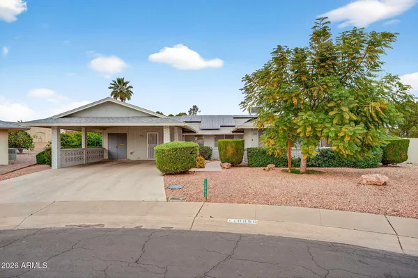 a view of a house with a yard and a garage