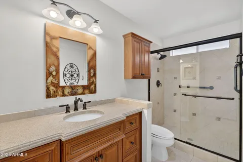 a white toilet sitting next to a bathroom sink