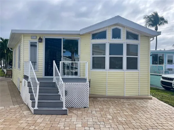 a front view of a house with a bench