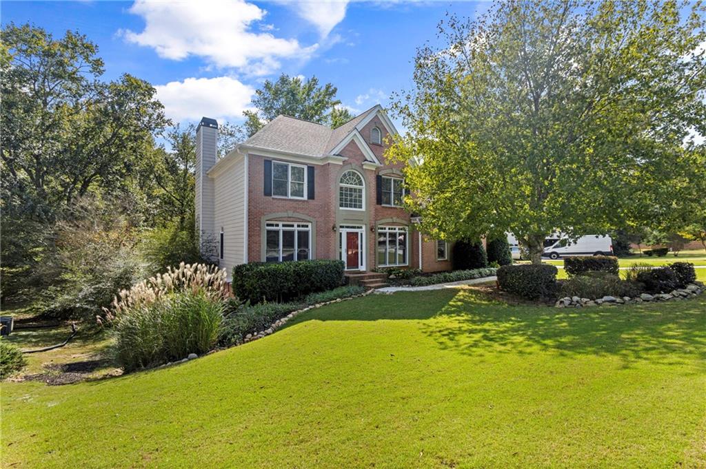 a view of a house with pool and sitting area