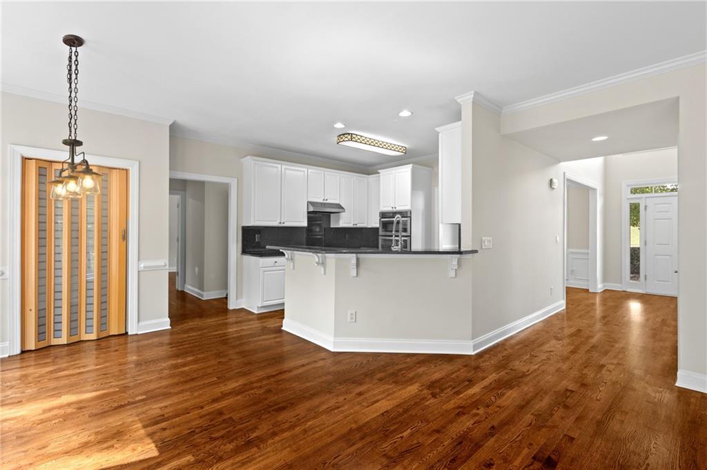 3685 Rolling Creek Drive Northeast Buford, GA 30519 - Photo 14 of 48 a view of a kitchen with cabinets and wooden floor