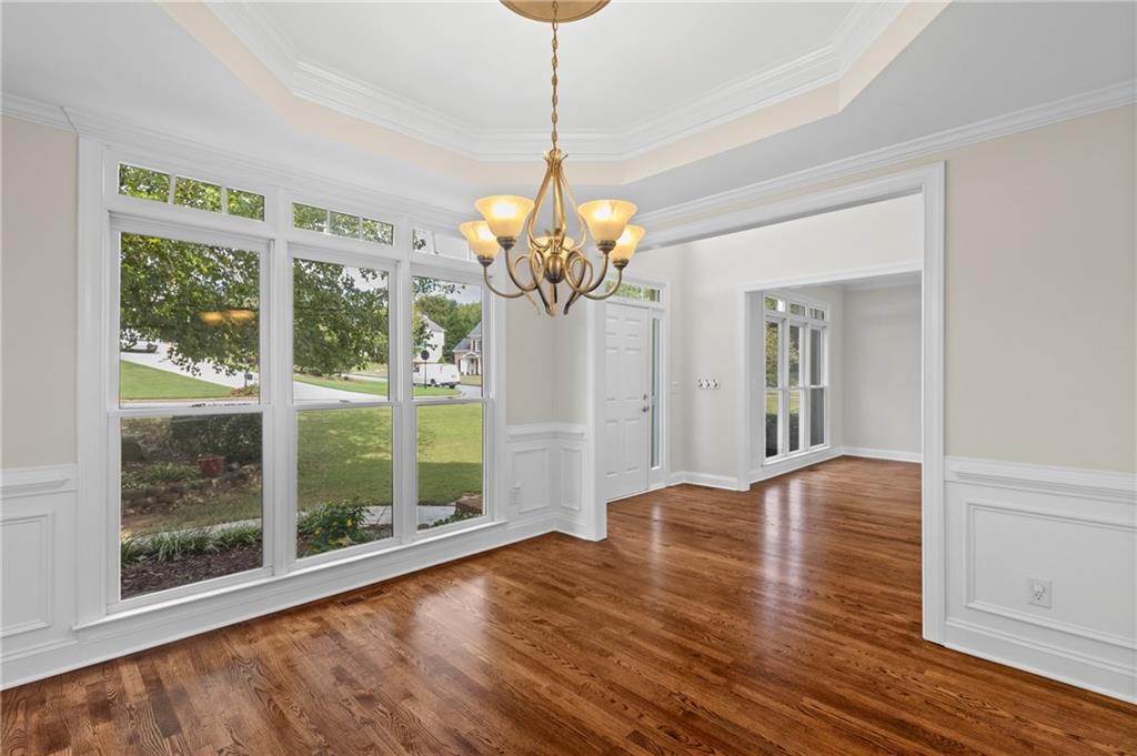 3685 Rolling Creek Drive Northeast Buford, GA 30519 - Photo 16 of 48 a view of a room with wooden floor and chandelier