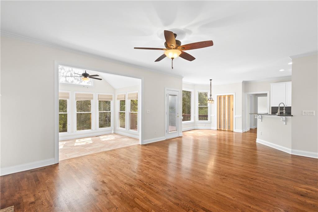 3685 Rolling Creek Drive Northeast Buford, GA 30519 - Photo 19 of 48 a view of an empty room with wooden floor and a window