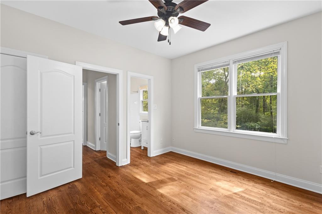 3685 Rolling Creek Drive Northeast Buford, GA 30519 - Photo 20 of 48 a view of empty room with wooden floor and fan