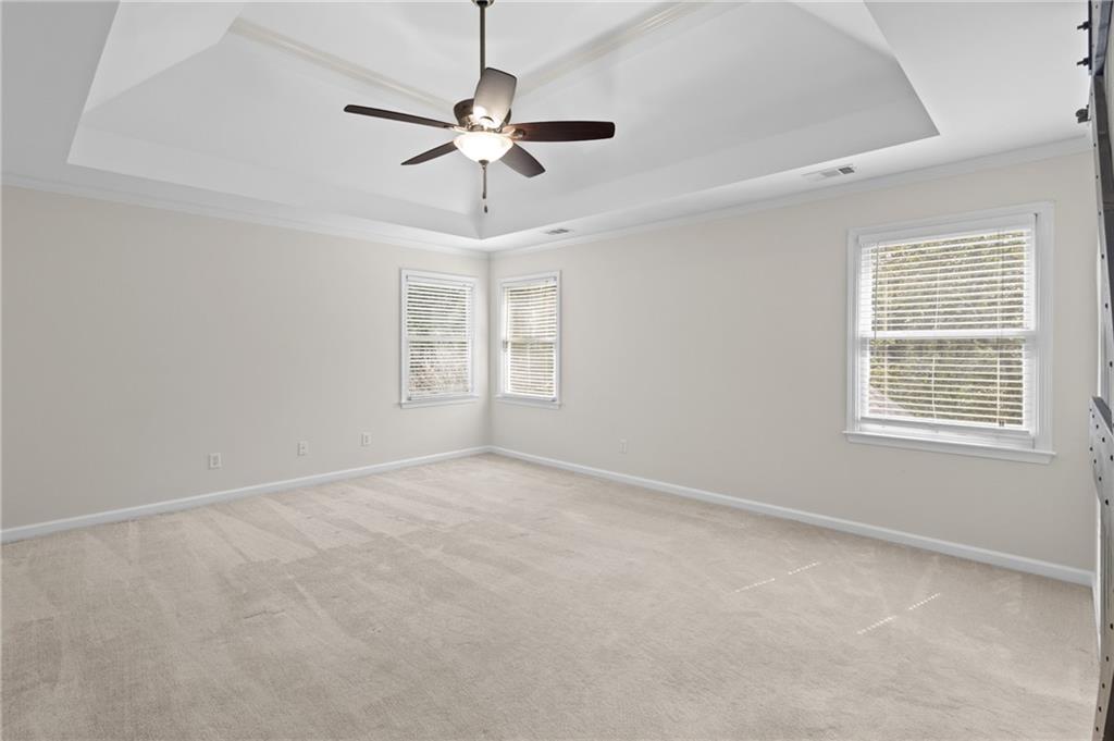 3685 Rolling Creek Drive Northeast Buford, GA 30519 - Photo 21 of 48 an empty room with windows and fan
