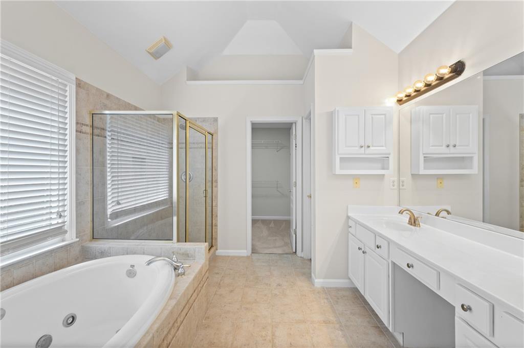 3685 Rolling Creek Drive Northeast Buford, GA 30519 - Photo 22 of 48 a spacious bathroom with a tub sink and mirror