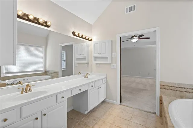 a spacious bathroom with a double vanity sink mirror and double