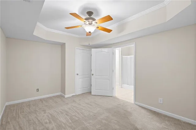 an empty room with ceiling fan and window