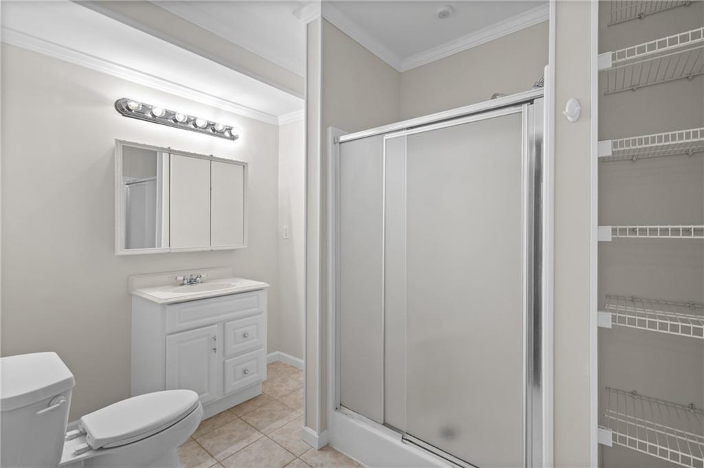 3685 Rolling Creek Drive Northeast Buford, GA 30519 - Photo 34 of 48 a spacious bathroom with a toilet a sink and a shower