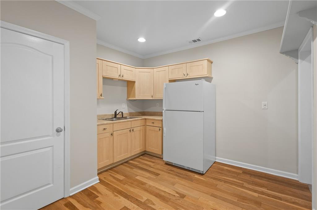 3685 Rolling Creek Drive Northeast Buford, GA 30519 - Photo 35 of 48 a kitchen with a refrigerator sink stove and cabinets
