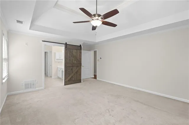 an empty room with ceiling fan and window
