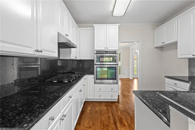 a kitchen with stainless steel appliances granite countertop a stove and a sink