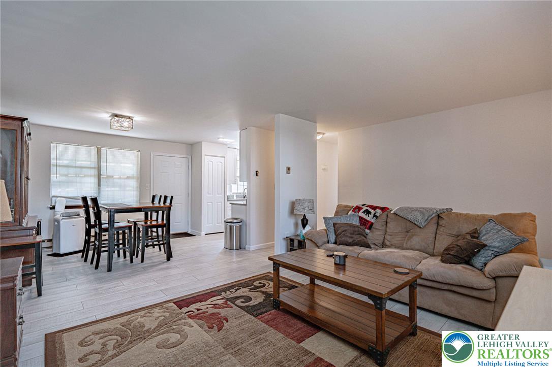 25 North 8th Street Emmaus, PA 18049 - Photo 6 of 51 An inviting open-concept living space features wood flooring and ample natural light.
