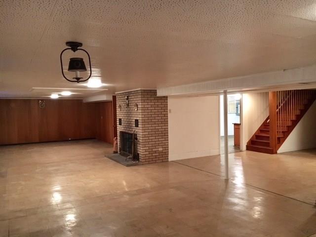 1125 State Road Monessen, PA 15062 - Photo 17 of 25 Large Family Room Area with Wood Burning Fireplace (hasn't been used in awhile). Extra Room in back is a Workshop.
