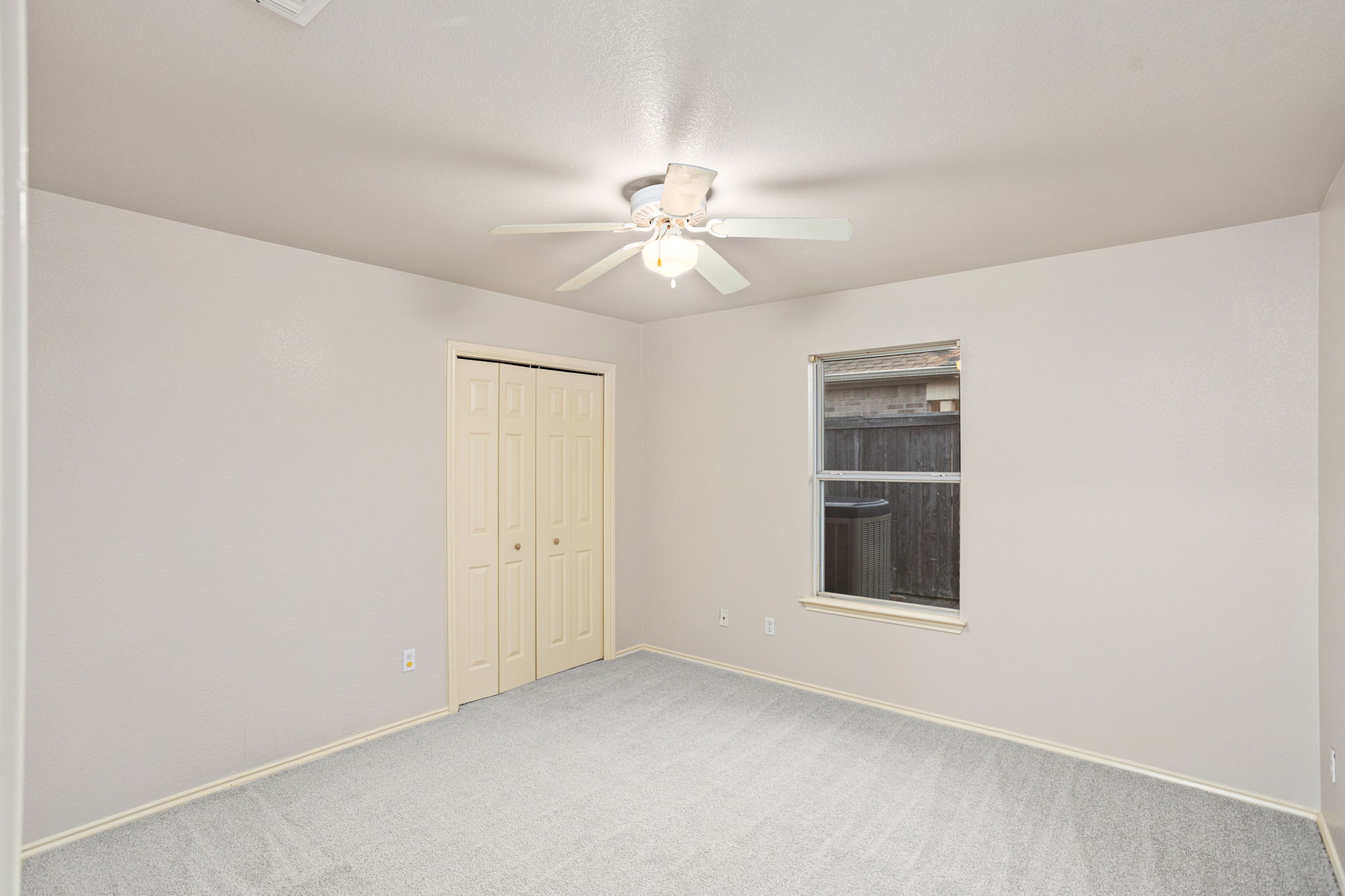 409 Lydia Lane Thrall, TX 76578 - Photo 17 of 25 an empty room with chandelier fan and windows