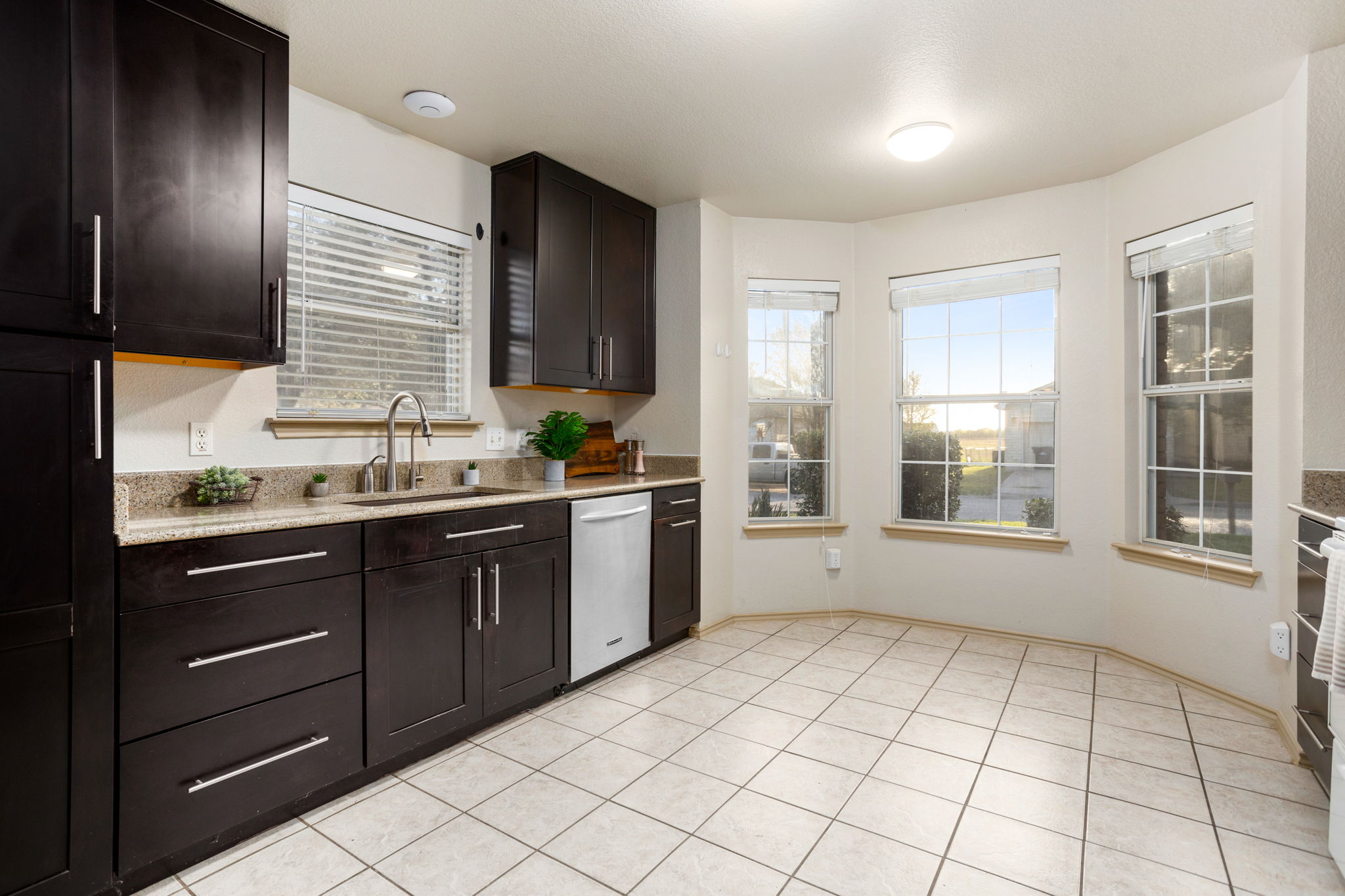409 Lydia Lane Thrall, TX 76578 - Photo 9 of 25 a kitchen with a sink window and cabinets