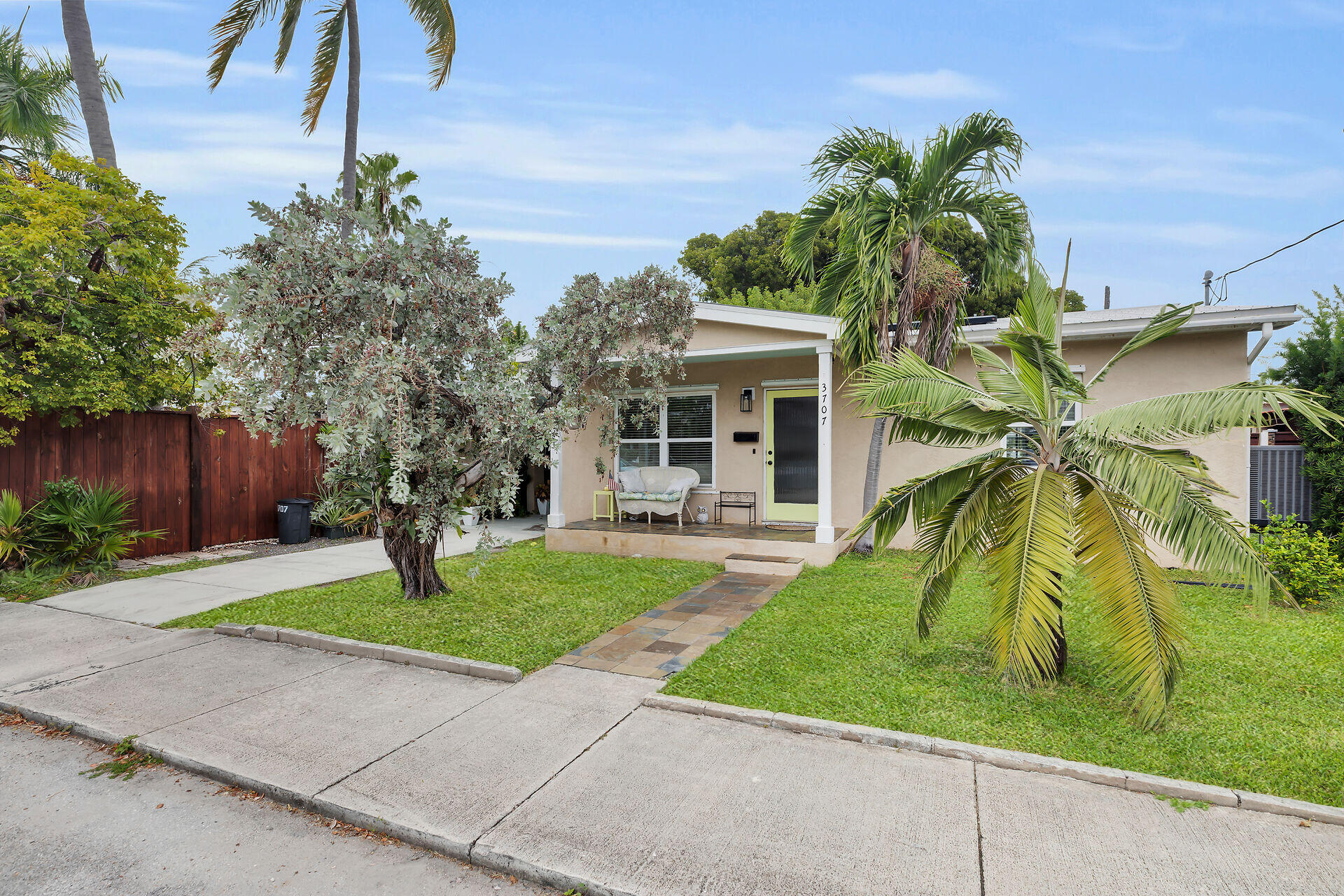 3707 Paula Avenue Key West, FL 33040 - Photo 2 of 26 a front view of a house with a garden and yard