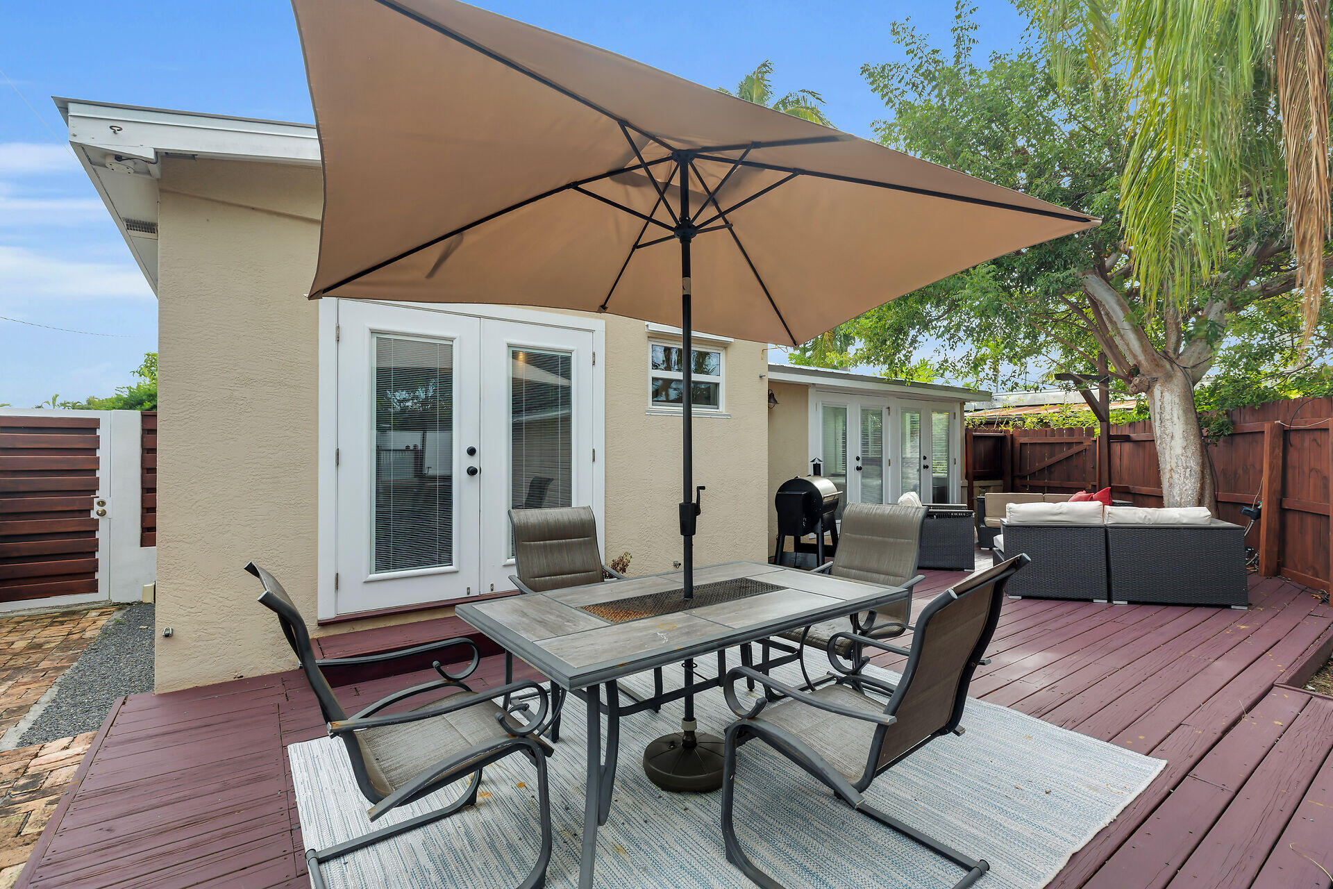 3707 Paula Avenue Key West, FL 33040 - Photo 22 of 26 a view of a patio with a table and chairs under an umbrella