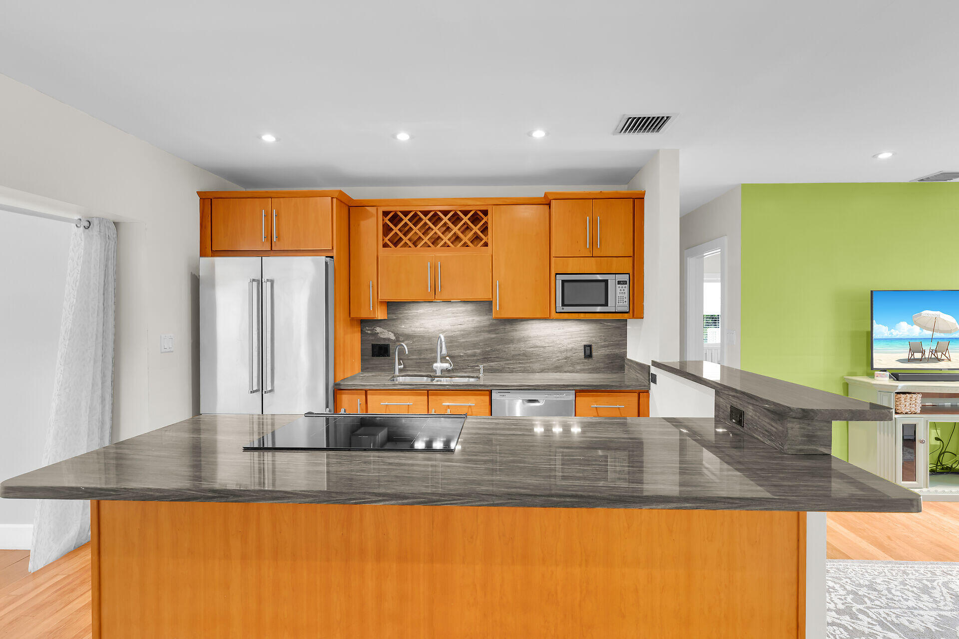 3707 Paula Avenue Key West, FL 33040 - Photo 10 of 26 a kitchen with stainless steel appliances granite countertop a sink and a wooden cabinets