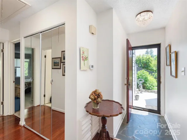 a view of a hallway with furniture and a window
