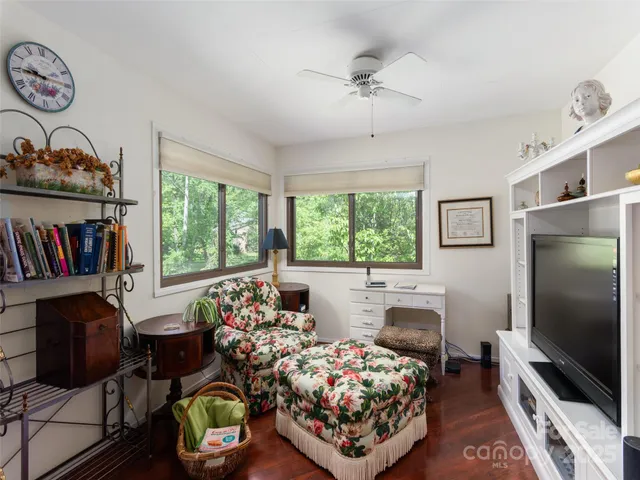 a bedroom with furniture and a flat screen tv