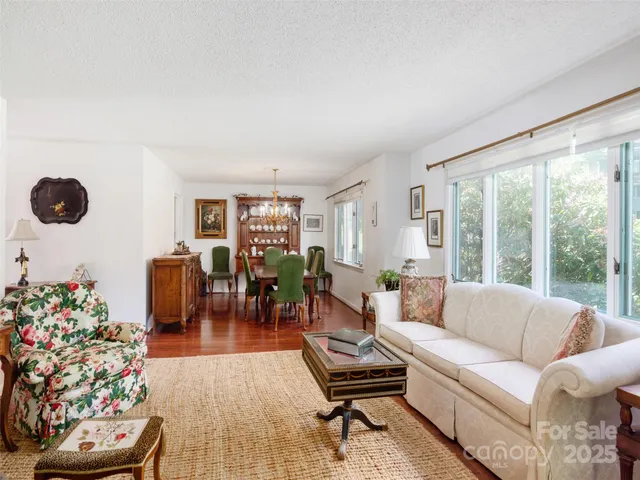 a living room with furniture and flowers