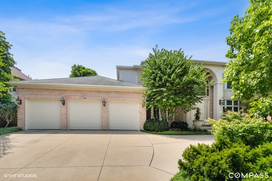 108 Riverside Drive Deerfield, IL 60015 - Photo 1 of 22 a white house with a yard and plants