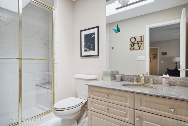 108 Riverside Drive Deerfield, IL 60015 - Photo 12 of 22 a bathroom with a granite countertop toilet sink and a mirror
