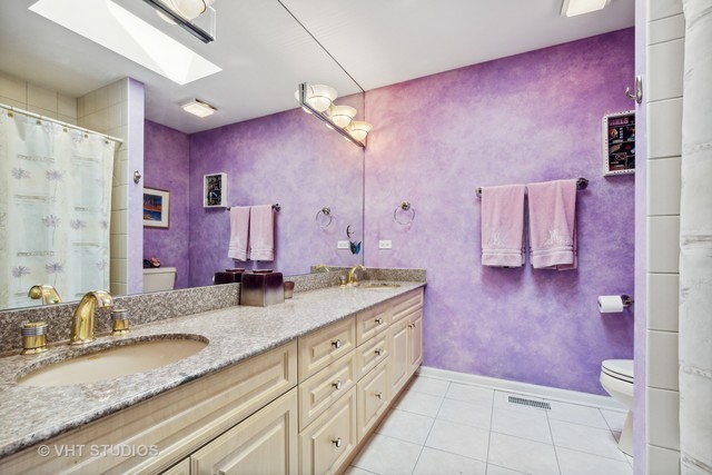 108 Riverside Drive Deerfield, IL 60015 - Photo 15 of 22 a bathroom with a granite countertop sink a mirror and a shower