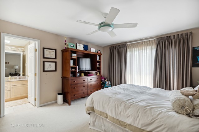 108 Riverside Drive Deerfield, IL 60015 - Photo 10 of 22 a bedroom with a bed and a flat screen tv