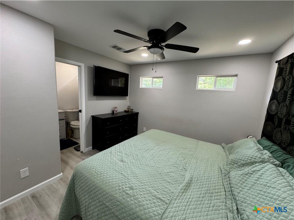 2409 Mitchell Avenue Waco, TX 76708 - Photo 12 of 17 a bedroom with a bed and a flat screen tv