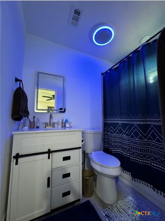 2409 Mitchell Avenue Waco, TX 76708 - Photo 13 of 17 a bathroom with a toilet sink and mirror