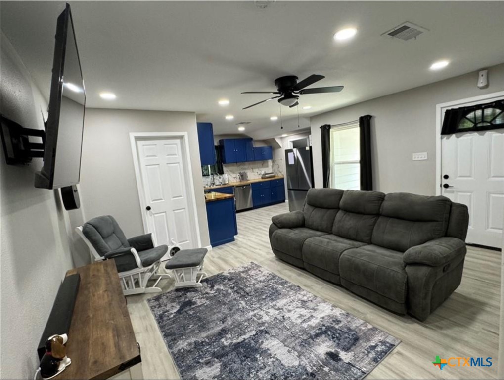 2409 Mitchell Avenue Waco, TX 76708 - Photo 8 of 17 a living room with furniture and a rug