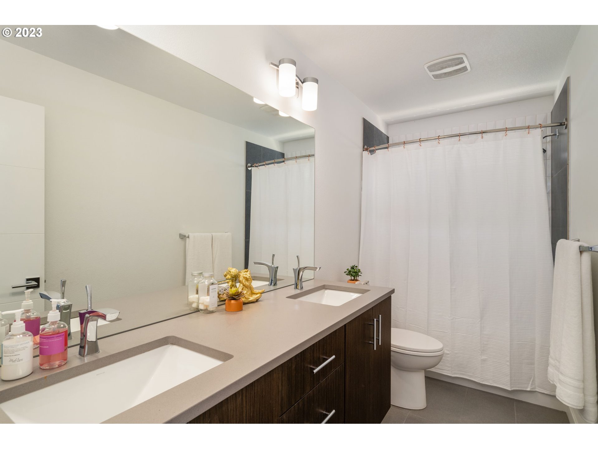 7660 Southwest 36th Avenue Portland, OR 97219 - Photo 19 of 40 a bathroom with a sink vanity and a mirror