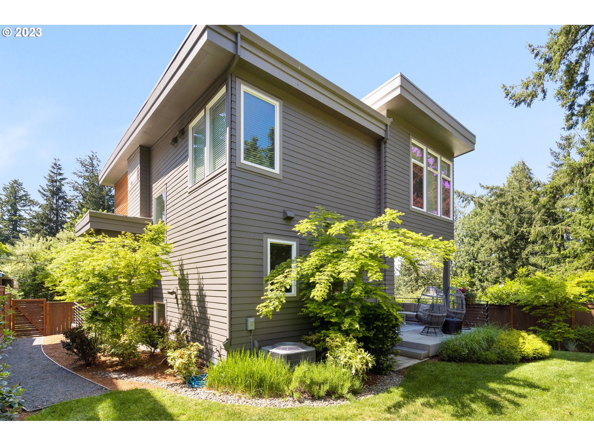 7660 Southwest 36th Avenue Portland, OR 97219 - Photo 28 of 40 a view of a house with a yard and potted plants