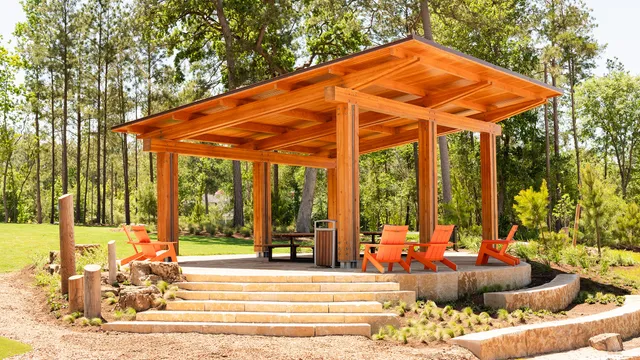 a view of a patio with table and chairs and floor to ceiling window