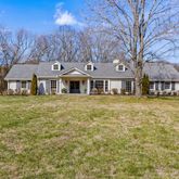a front view of a house with a garden and plants
