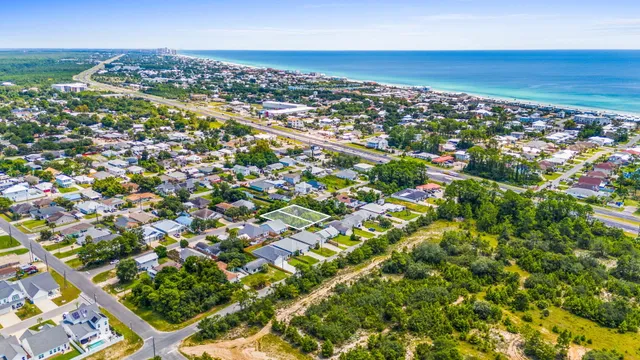 an aerial view of residential houses with city view