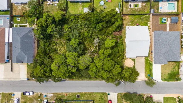 an aerial view of residential houses with city view