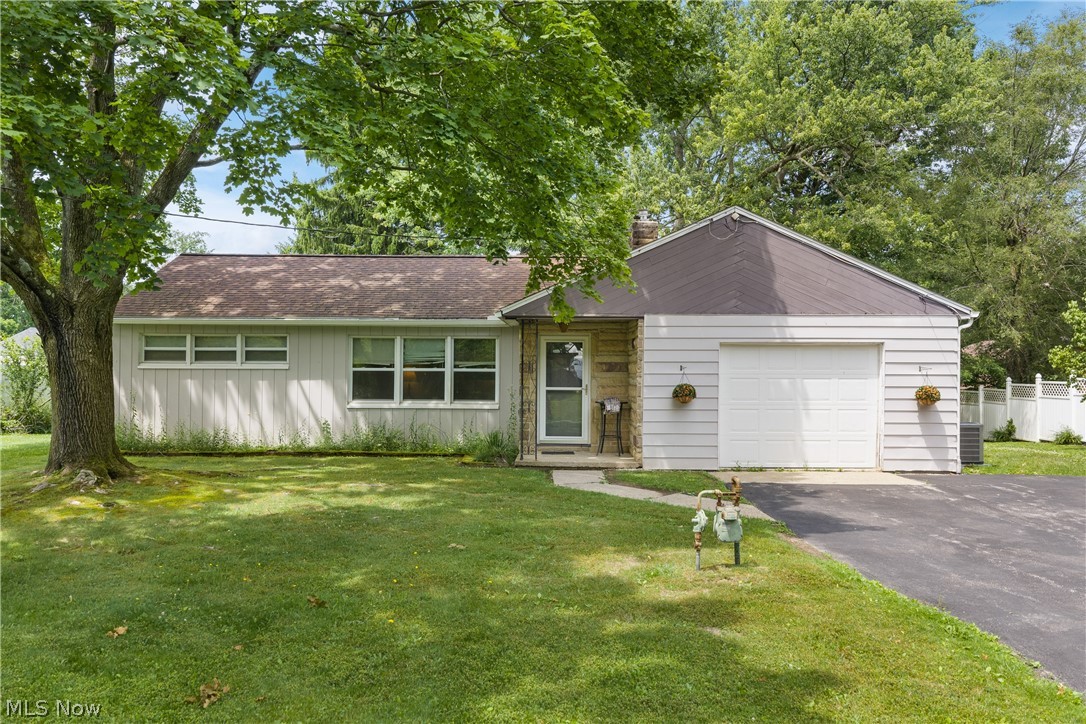 5768 Nolley Road Akron, OH 44319 - Photo 3 of 38 Ranch-style residence featuring horizontal siding, a single-car garage, and a paved driveway