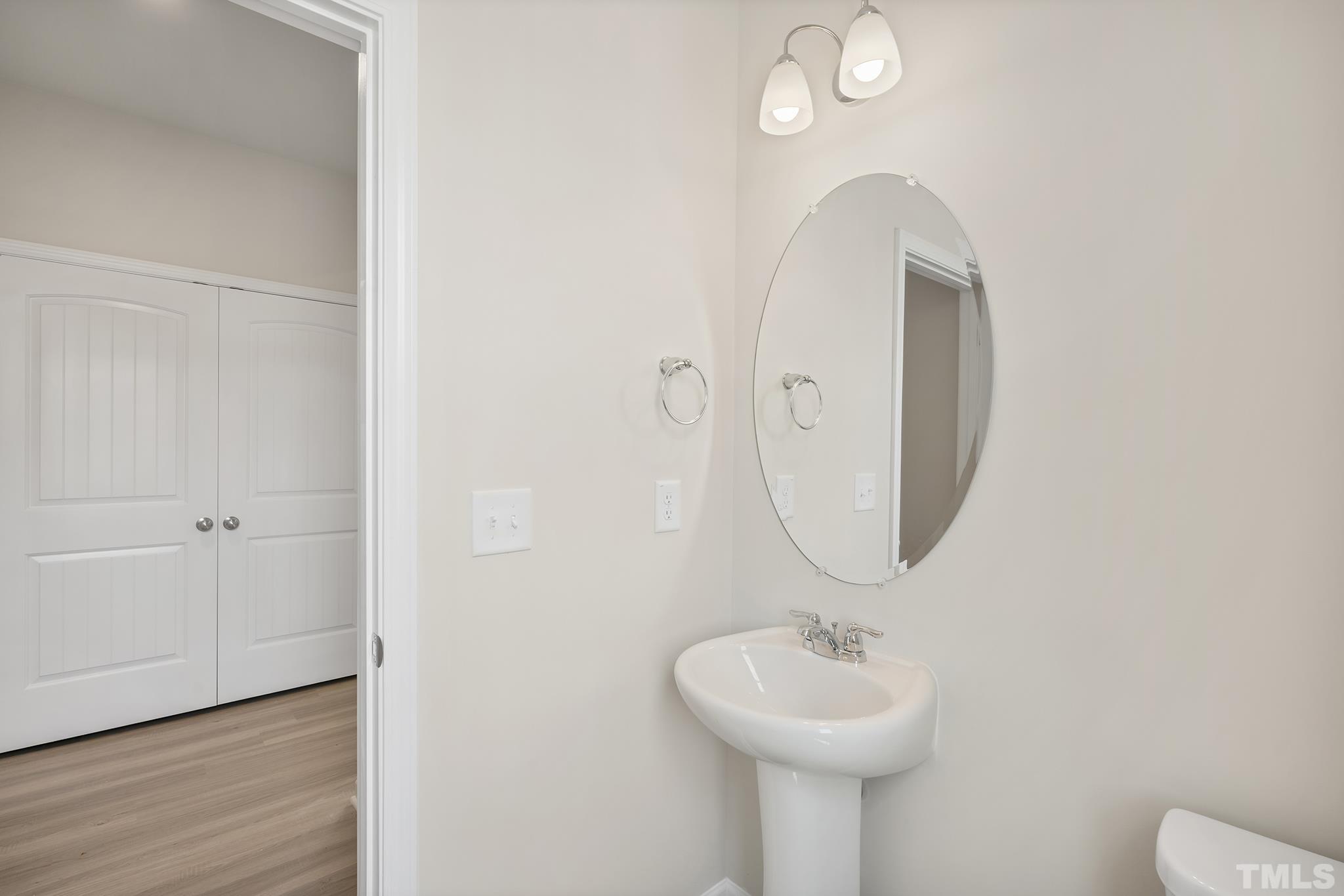 166 Karlov Road Garner, NC 27529 - Photo 3 of 29 a bathroom with a sink and a mirror