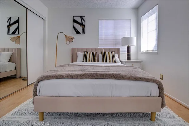 a bedroom with a bed and a lamp