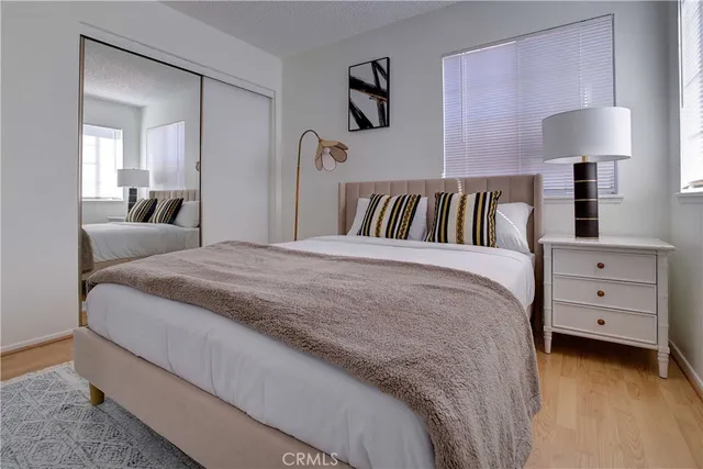 a spacious bedroom with a bed and a lamp