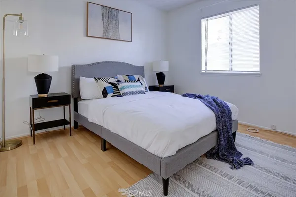 a bedroom with a bed and a window