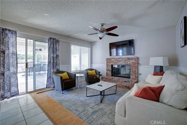 a living room with furniture a fireplace and a flat screen tv