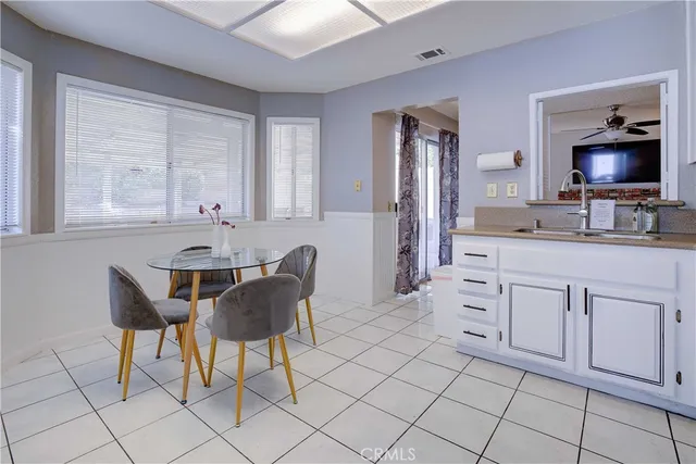 a kitchen with cabinets and chairs