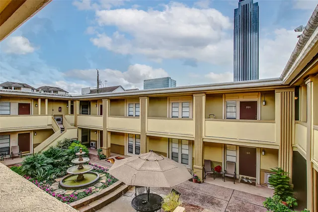 a front view of a residential apartment building with a yard