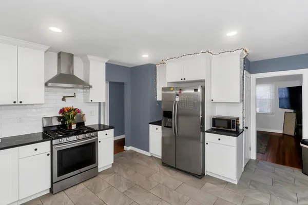 a kitchen with stainless steel appliances a refrigerator sink and stove
