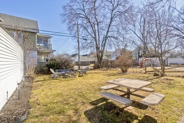 a view of a house with snow on the roadside